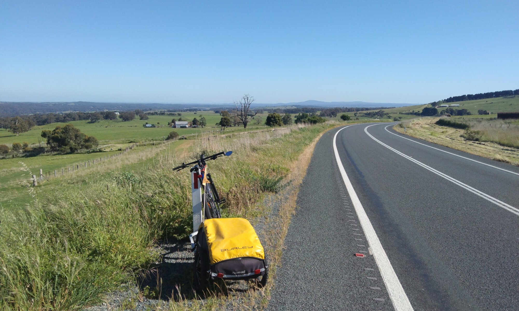 Bicycle and trailer by the side of a highway in the Victorian midlands.
